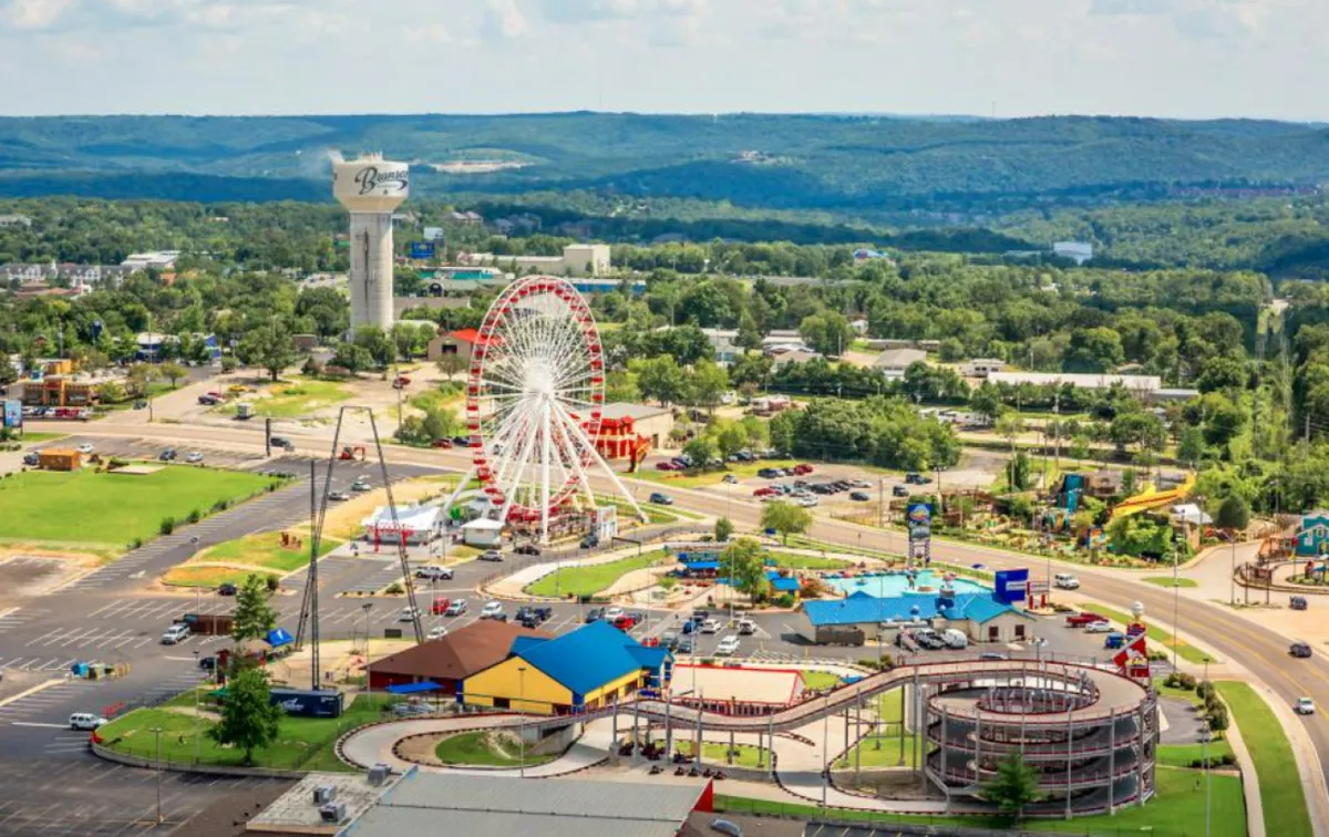 This image showcases a vibrant amusement park scene, with a Ferris wheel, colorful rides, and lively buildings. The bright atmosphere is filled with excitement and family fun, perfectly capturing the thrill of theme park adventures.