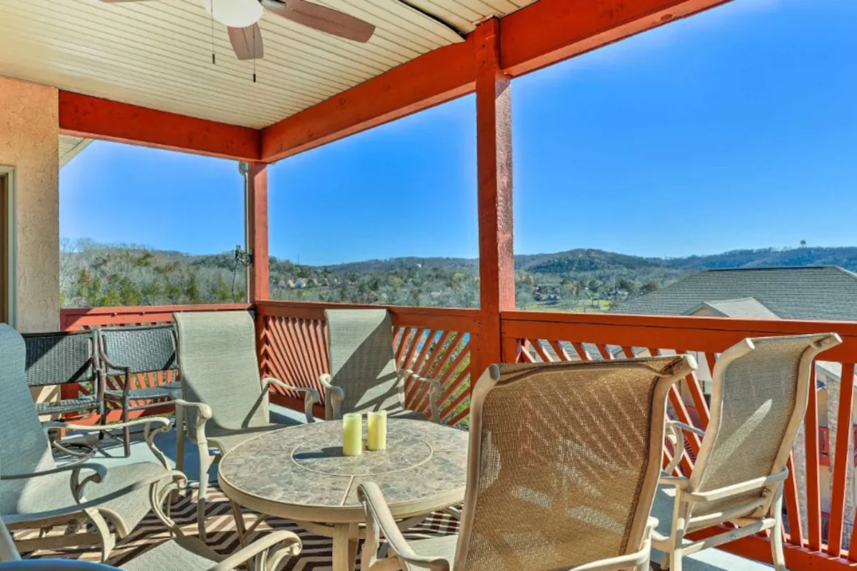 This exterior image captures a serene outdoor seating area on a private deck with a table set with candles. The vantage point provides a sweeping view of the rolling hills. The mood is peaceful, perfect for relaxation at sunrise or sunset, and the arrangement invites guests to enjoy their morning coffee or evening wine while taking in the scenic surroundings.